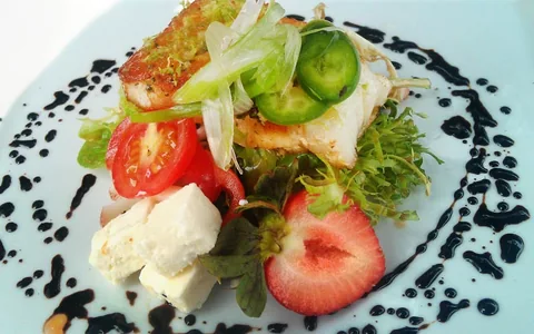 A plated salad with fresh vegetables.